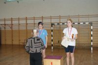 Kobieta gratuluje dziewczynce stojącej na podium