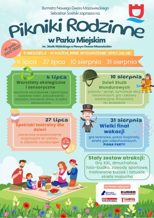 Kobieta, mężczyzna, dziewczynka i chłopiec siedzący na kocu na łące. Mężczyzna w cylindrze, maski teatralne, dwóch strażaków.