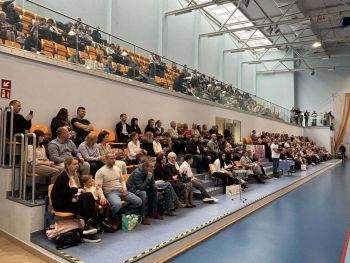 hala sportowa, dzieci ubrane na galowo, zaproszeni goście, występy z biało czerwonymi flagami