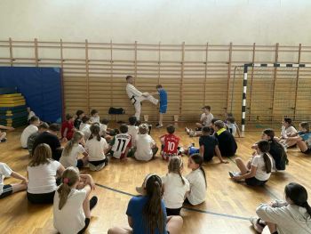 sale gimnastyczne w szkołach, ćwiczące dzieci, instruktorzy