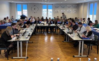 sala posiedzeń, radny zebrani przy stole konferencyjnym ustawionym w literę u