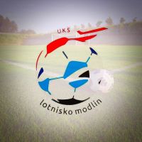 zarys piłki z kolorowych elementów, napis UKS Lotnisko Modlin