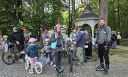 osoby na rolkach, rowerach i hulajnogach jadące ulicami Twierdzy Modlin,