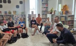 sala w bibliotece, zebrana młodzież siedzi na krzesełkach,
